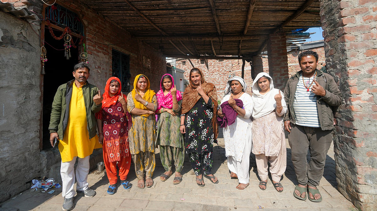 Pakistani Hindu refugees show their fingers marked with indelible ink after casting their votes for the first time during the Delhi Assembly elections, at resettlement colony in Majnu Ka Tila area, in New Delhi, Wednesday, Feb. 5, 2025. - PTI/Shahbaz Khan