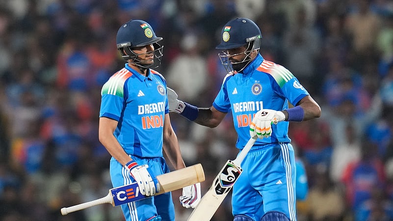Indias Shubman Gill, left, walks off the field after losing his wicket. AP Photo