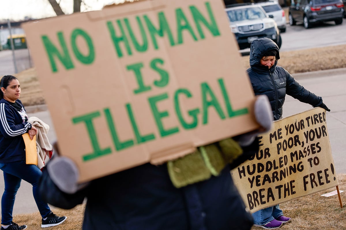 Signs of support are seen during a protective accompaniment vigil as people arrive for their immigration appointments outside of the Cedar Rapids U.S. Immigration and Customs Enforcement (ICE) office in Cedar Rapids, Iowa, on Tuesday, Feb. 4, 2025.  - Jim Slosiarek/The Gazette Via AP