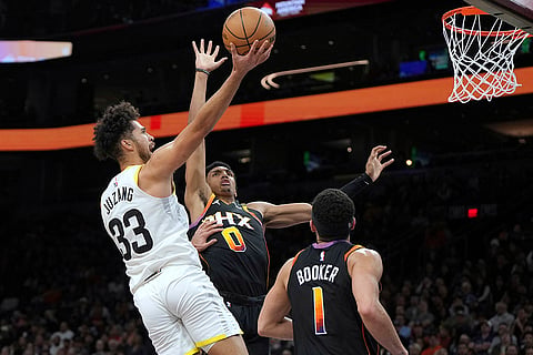 NBA 2024-25: Jazz guard Johnny Juzang shoots over Phoenix Suns forward Ryan Dunn