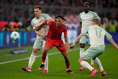 Bundesliga 2024-25: Bayern's Sacha Boey fights for the ball with Bremen's Senne Lynen