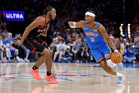 NBA 2024-25: Thunder guard Shai Gilgeous-Alexander (2) drives against Raptors guard Immanuel Quickley