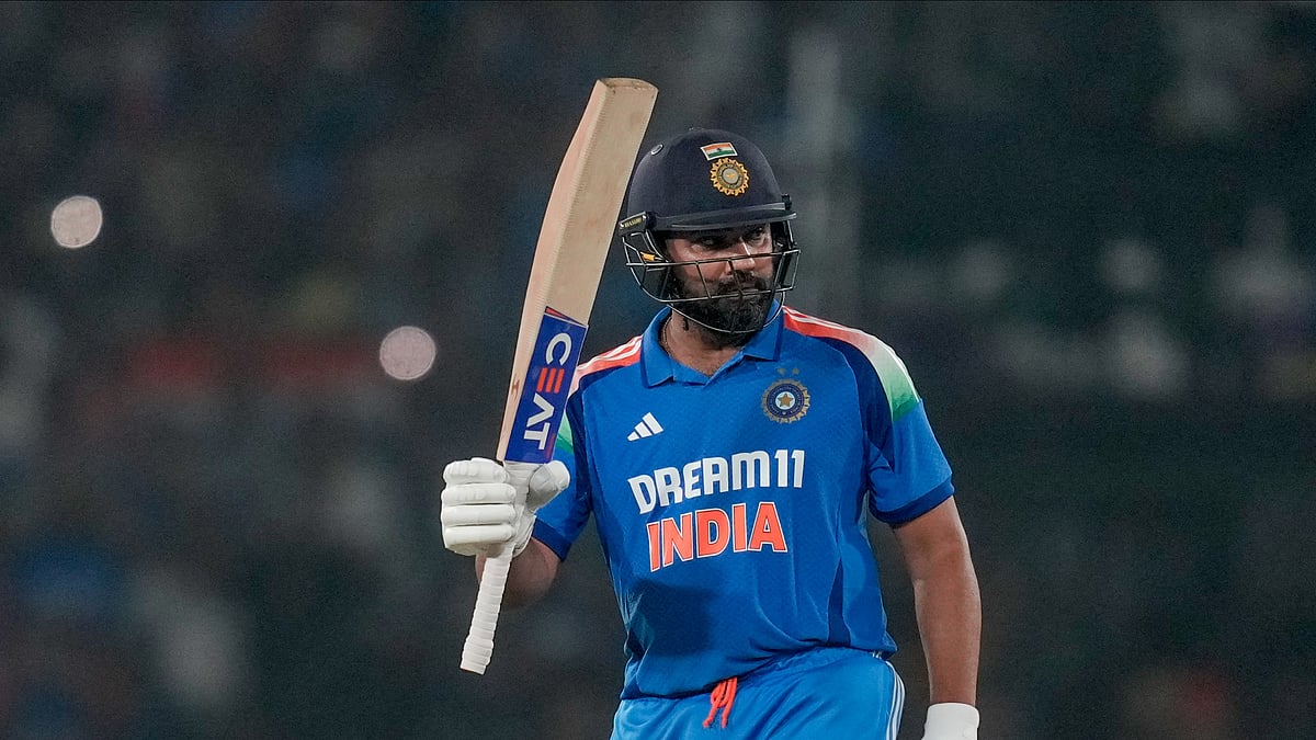 Indias captain Rohit Sharma raises his bat. AP Photo