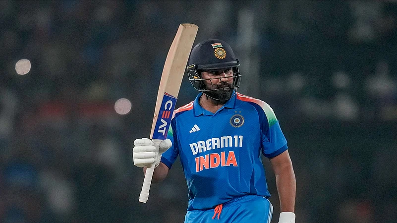 Indias captain Rohit Sharma raises his bat. AP Photo