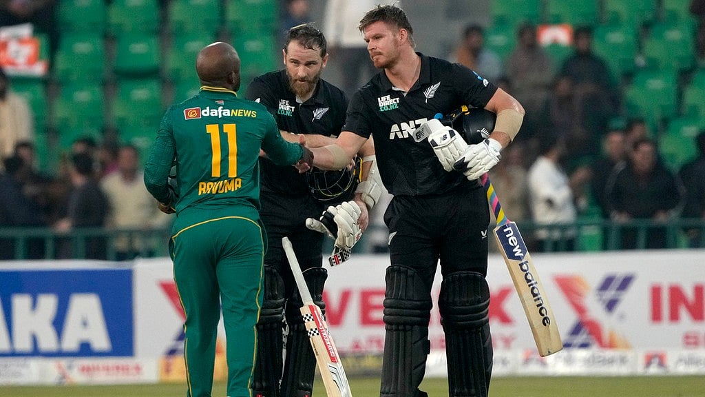 Kane Williamson, centre, and Glenn Phillips, right, shake hands with Temba Bavuma