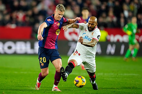 La Liga 2024-25: Sevilla's Marcao vies for the ball with Barcelona's Dani Olmo