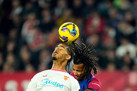 La Liga 2024-25: Sevilla's Loic Bade jumps for the ball with Barcelona's Jules Kounde