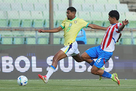 CONMEBOL U20 Championship: Brazil's Gustavo Prado runs for the ball chased by Paraguay's Angel Aguayo