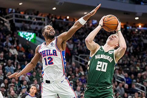 NBA 2024-25: Bucks' AJ Green (20) is fouled by 76ers' Jared Bulter 