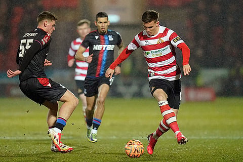 FA Cup Fourth Round: Crystal Palace's Justin Devenny and Doncaster Rovers' George Broadbent challenge for the ball 