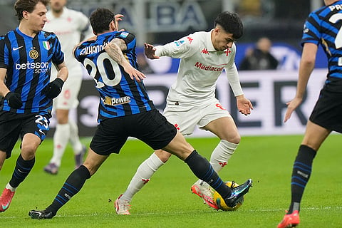 Serie A: Inter Milan's Hakan Calhanoglu challenges for the ball with Fiorentina's Fabiano Parisi 