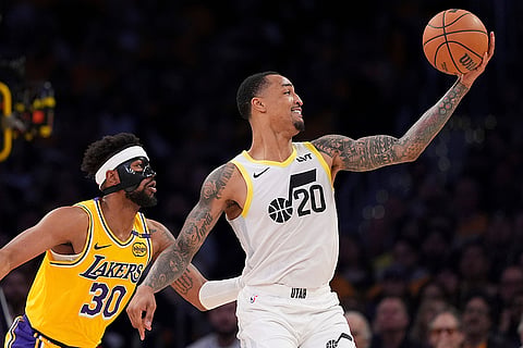 NBA 2024-25: Jazz forward John Collins looks to pass as Lakers guard Jordan Goodwin defends 