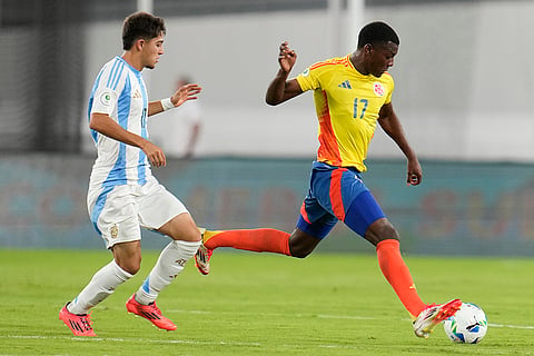 CONMEBOL U20 Championship: Colombia's Juan Arizala carries for the ball chased by Argentina's Valentino Acuna