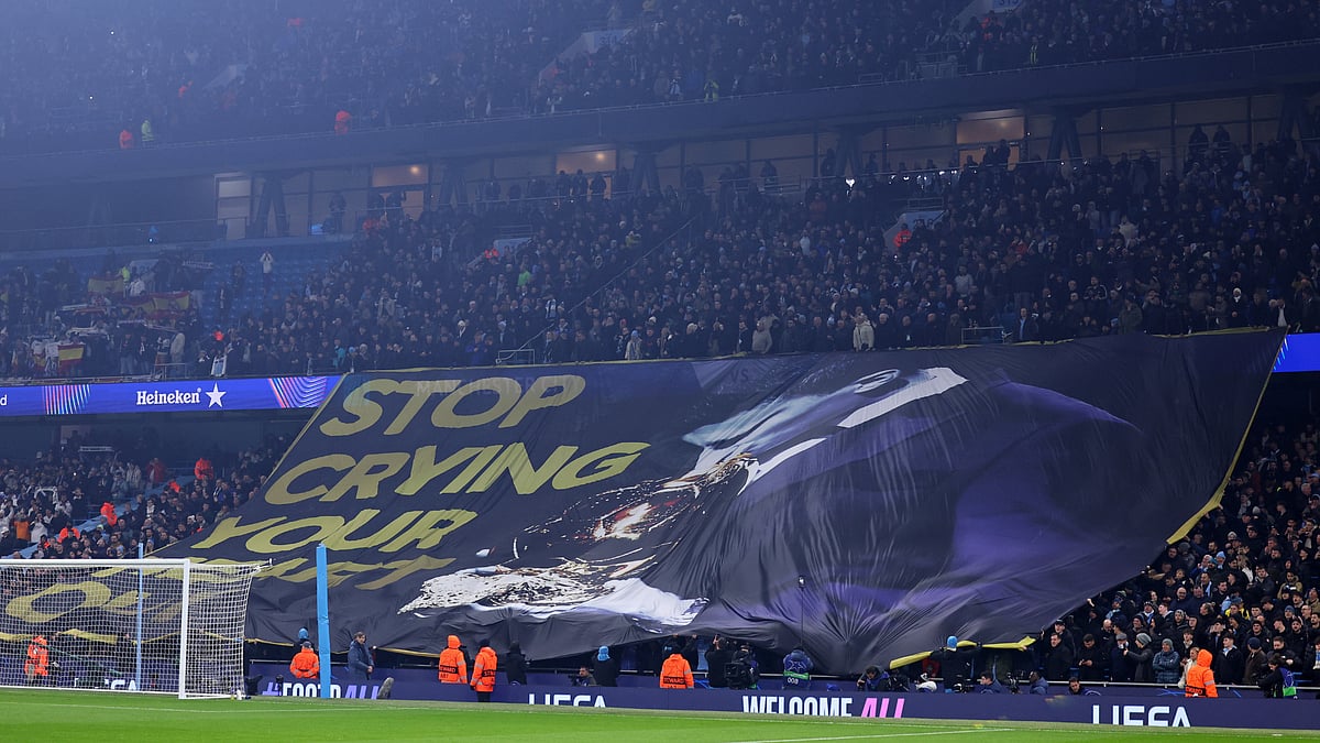 Manchester City fans parade a banner mocking Vinicius Junior - null