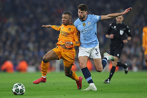 Champions League playoff first leg: Manchester City's Ruben Dias challenges Real Madrid's Kylian Mbappe