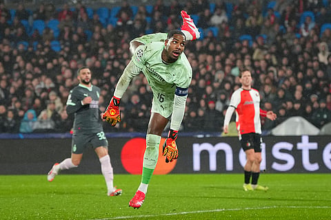 Champions League playoff first leg: AC Milan's goalkeeper Mike Maignan dives to save a shot