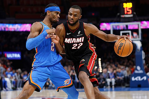 NBA 2024-25: Heat forward Andrew Wiggins (22) drives against Thunder guard Shai Gilgeous-Alexander