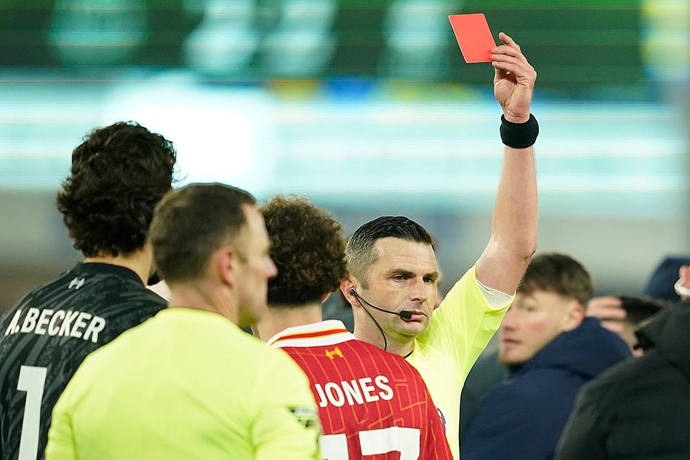 | Photo: AP/Dave Thompson : EPL 2024-25: Referee Michael Oliver shows a red card to Liverpool's Curtis Jones