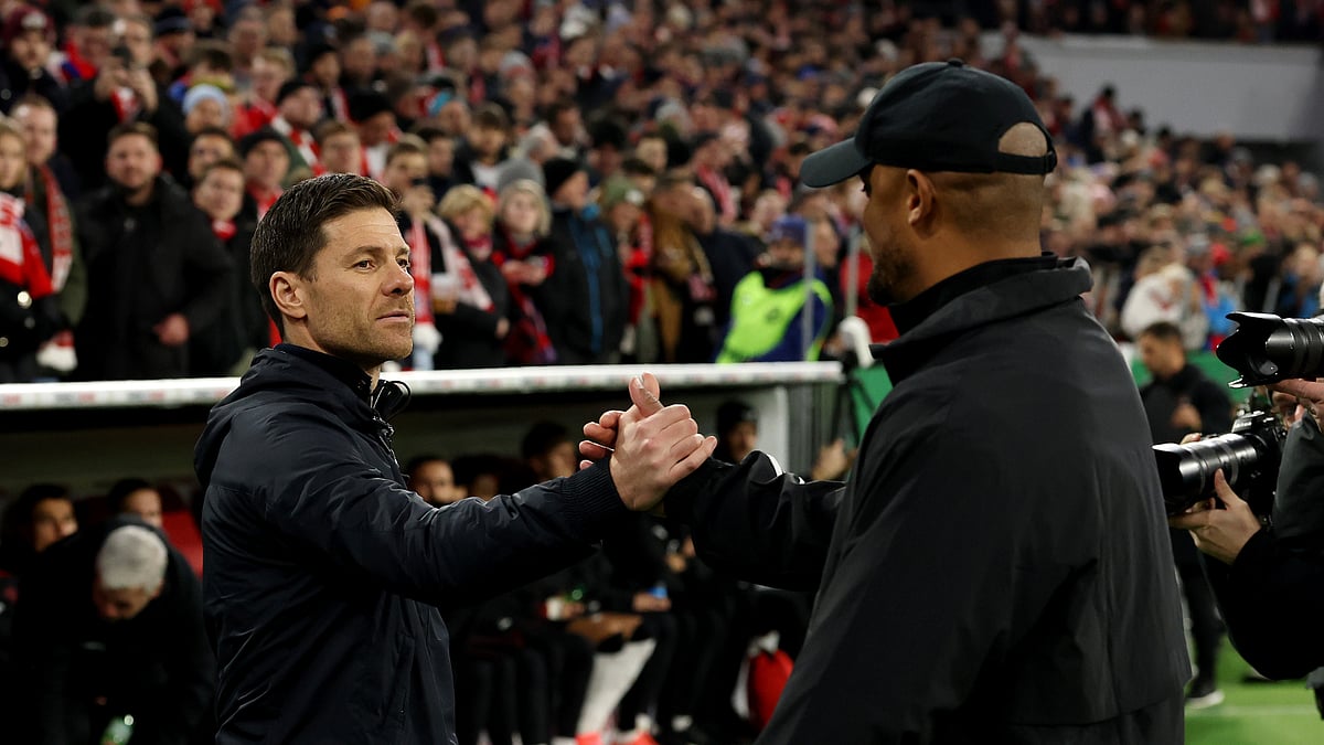 Xabi Alonso and Vincent Kompany share a handshake. - null