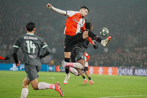 Champions League playoff first leg: Feyenoord's Jakub Moder jumps for a header with AC Milan's Rafael Leao 