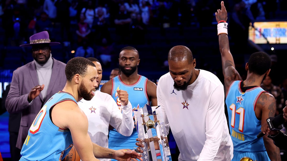 Stephen Curry (left) and Kevin Durant (right) lift the trophy after winning the 2025 NBA All-Star Game.