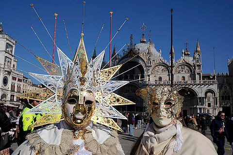 Venice Carnival 2025: People wear masks in front of the St. Mark's Basilica