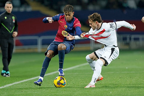La Liga 2024-25: Barcelona's Lamine Yamal challenges for the ball with Rayo's Pep Chavarria 