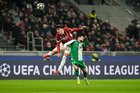 Champions League Soccer playoff second leg: AC Milan's Davide Bartesaghi jumps for a header with Feyenoord's Anis Hadj Moussa 