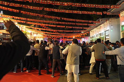 BJP supporters celebrate amid its legislature party meeting, outside the party office in New Delhi.