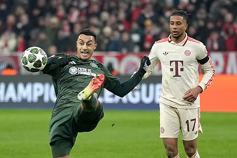 Champions League Soccer playoff second leg: Celtic's Adam Idah, left, kicks the ball ahead of Bayern's Michael Olise 