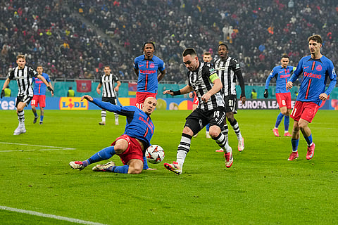 Europa League playoff second leg, FCSB vs PAOK: FCSB's Vlad Chiriches tackles PAOK's Andrija Zivkovic 