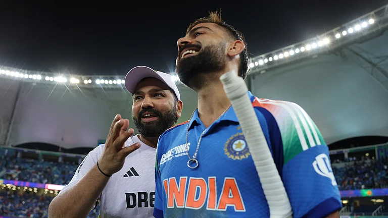 Rohit Sharma and Virat Kohli walk off smiling after Sunday's win in Dubai - null