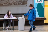 Getty Images : A voter casts his ballot for the German federal parliamentary elections at a local polling station on February 23