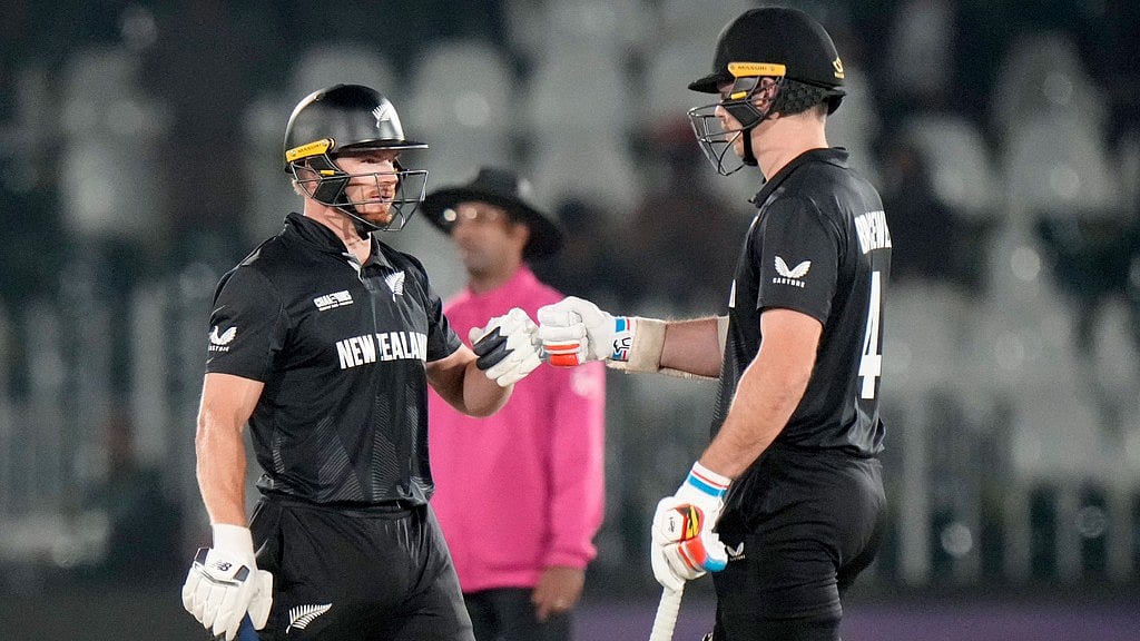 Photo: AP : Glenn Phillips, left, celebrates with Michael Bracewell after New Zealand beat Bangladesh in the Champions Trophy.