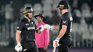 Photo: AP : Glenn Phillips, left, celebrates with Michael Bracewell after New Zealand beat Bangladesh in the Champions Trophy.