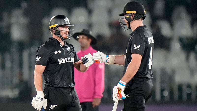 Glenn Phillips celebrates with Michael Bracewell after New Zealand beat Bangladesh