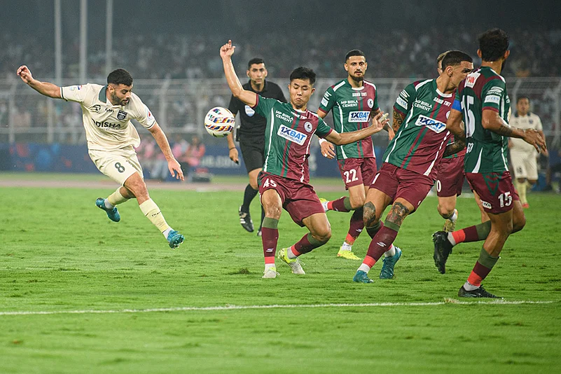 Odisha FC midfielder Hugo Boumous heads the ball during the ISL match against Mohun Bagan