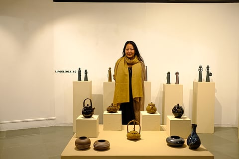 Artist Lipoklemla Ao, an artist from Nagaland, with her exhibited artwork |