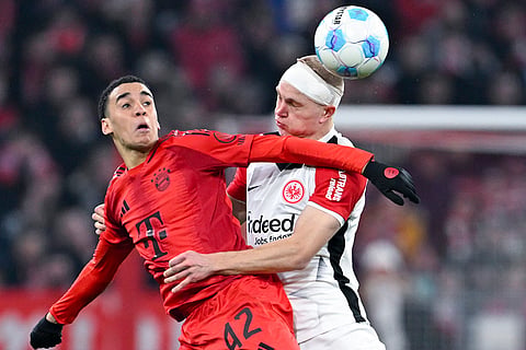 Bundesliga 2024-25, Bayern vs Eintracht: Jamal Musiala of Munich and Rasmus Kristensen of Frankfurt
