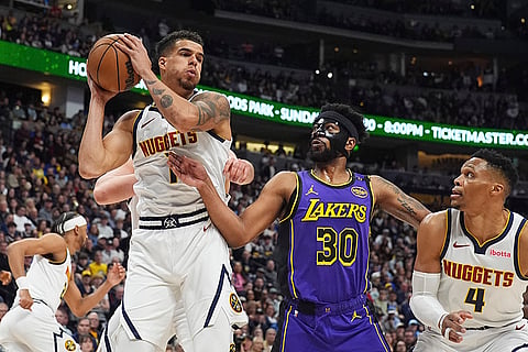 NBA 2024-25, Lakers vs Nuggets: Nuggets forward Michael Porter Jr., left, pulls in a rebound 