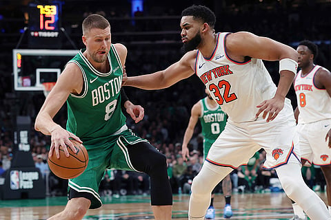 NBA 2024-25, Knicks vs Celtics: Celtics' Kristaps Porzingis (8) looks to move against Knicks' Karl-Anthony Towns