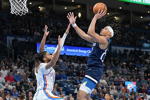NBA 2024-25, Timberwolves vs Thunder: Timberwolves guard Terrence Shannon Jr., right, goes up to shoot 