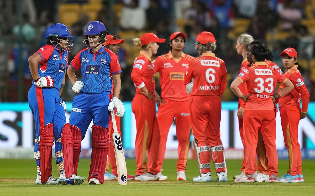 (PTI Photo/Shailendra Bhojak)  : Bengaluru: Delhi Capitals' batters Jess Jonassen and Shafali Verma interact with each other as Gujarat Giants' players wait for third umpire's decision during a Women's Premier League (WPL) 2025 cricket match between Delhi Capitals and Gujarat Giants, at the M Chinnaswamy Stadium, in Bengaluru, Tuesday, Feb. 25, 2025. 