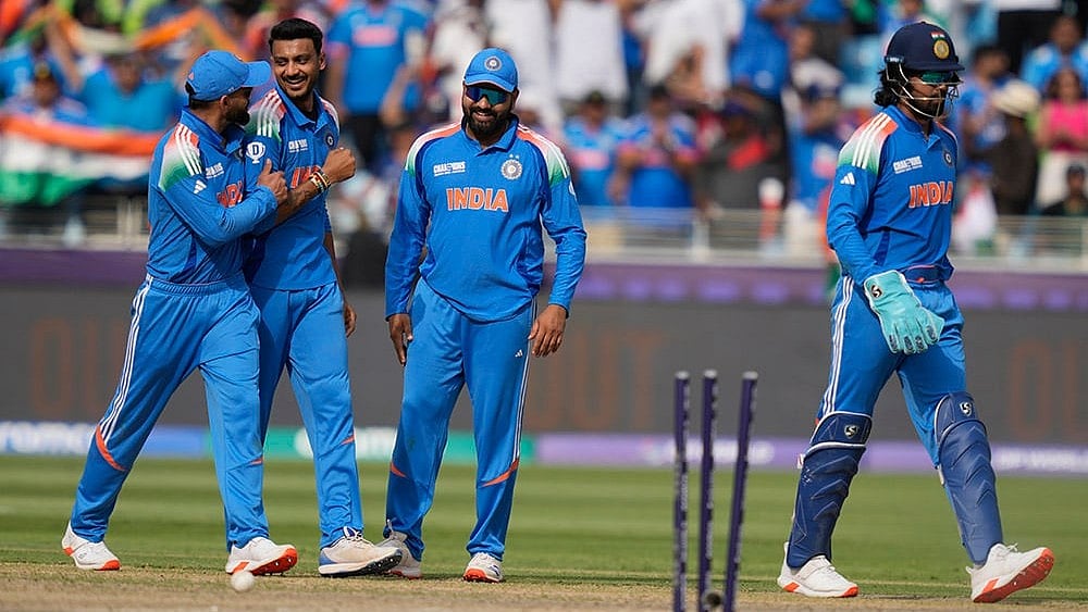 | Photo: AP/Altaf Qadri : ICC Champions Trophy, IND vs PAK: India's Axar Patel celebrates with teammate the wicket of Pakistan's captain Mohammad Rizwan