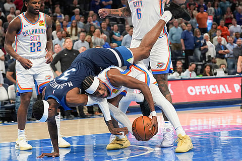 NBA 2024-25, Timberwolves vs Thunder: Timberwolves forward Jaden McDaniels falls on Thunder guard Shai Gilgeous-Alexander