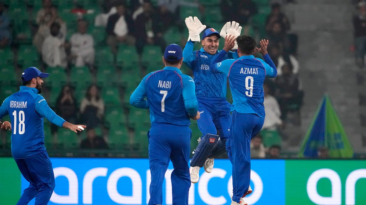 AP Photo/K.M. Chaudary : Afghanistan's Azmatullah Omarzai, right, celebrates with teammates after the dismissal of England's Philip Salt during the ICC Champions Trophy cricket match between Afghanistan and England, in Lahore.