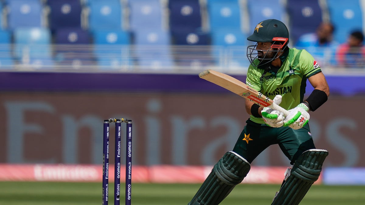 AP Photo/Altaf Qadri : Pakistan's captain Mohammad Rizwan plays a shot during the ICC Champions Trophy cricket match between India and Pakistan at Dubai International Cricket Stadium. 