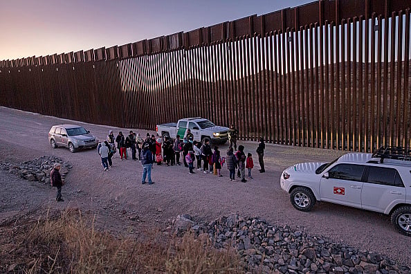 Getty images : U.S. Border Patrol agents prepare to transport immigrants for processing next to the U.S.-Mexico border fence on January 19, 2025 near Sasabe, Arizona |