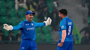 AP Photo/K.M. Chaudary : Afghanistan's Azmatullah Omarzai, right, celebrates with teammate after taking the wicket of England's Joe Root during the ICC Champions Trophy cricket match between Afghanistan and England, in Lahore.