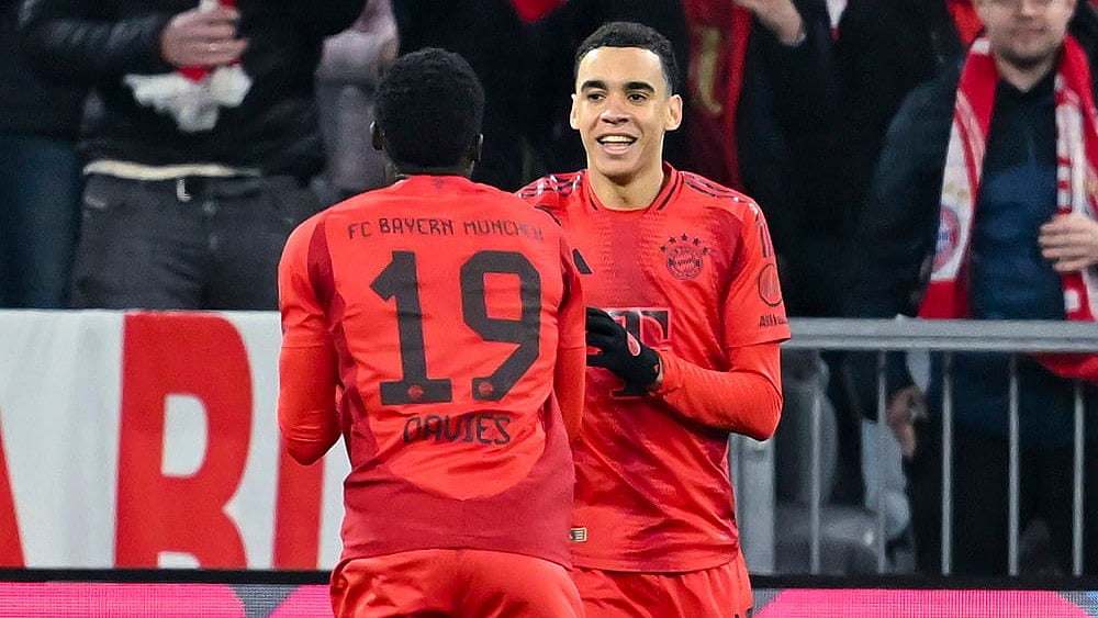 | Photo: Sven Hoppe/dpa via AP : Bundesliga 2024-25, Bayern vs Eintracht: Munich's Jamal Musiala celebrates scoring with Alphonso Davies 